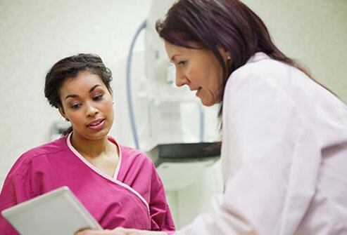 A doctor answers a young female patient's question.