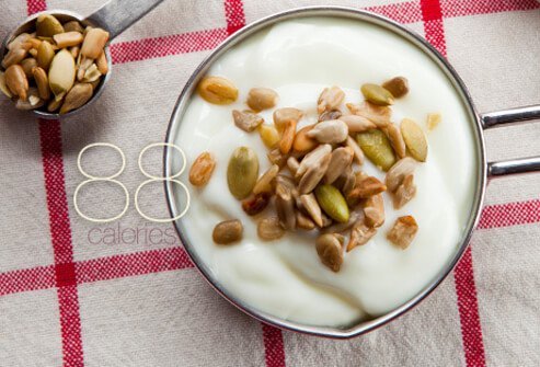 Yogurt topped with sunflower seeds.