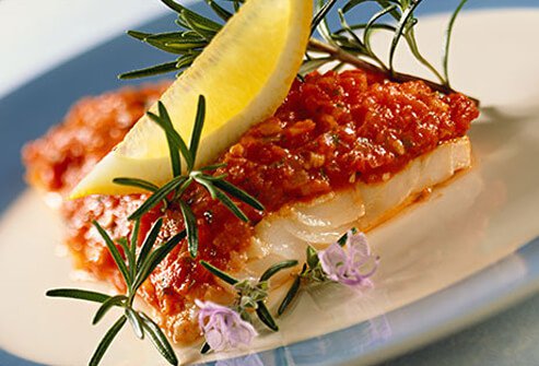 Photo of cod with tomato sauce and rosemary.