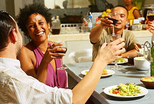 Photo of friends enjoying wine at dinner.