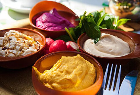 Photo of bowls of hummus and bean dips.