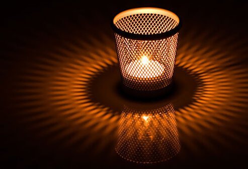 Bright indoor lights inhibit the production of melatonin, the hormone that helps you fall asleep.