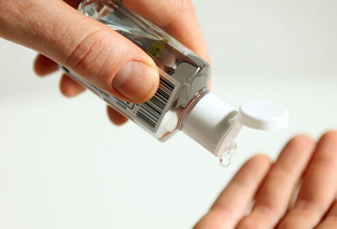 A person uses hand sanitizer.