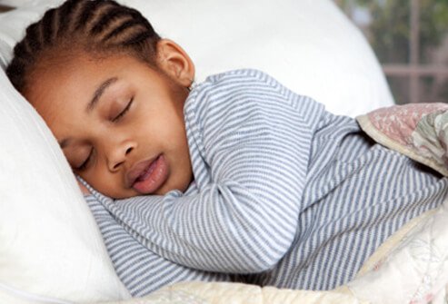 Lying on your stomach or face down may help alleviate a bellyache.