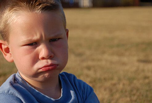 A boy is not happy about having to wait his turn.