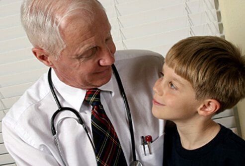 A doctor talks to a boy with ADHD.