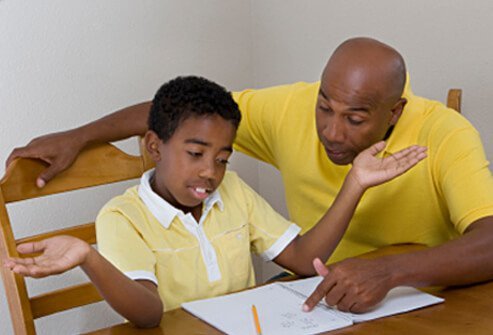 A father tries to help his son who doesn't understand and is giving up on homework.