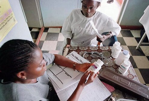 A woman receives medicine in a Nigerian AIDS clinic.