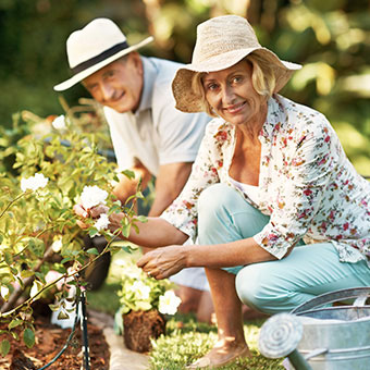 A senior couple out in the garden.