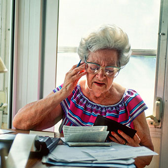 A senior woman struggling to work on finances.