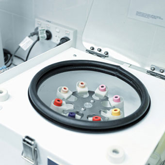 A centrifuge holding various tubes of blood.