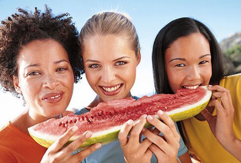 Photo of women sharing skin healthy fruit.
