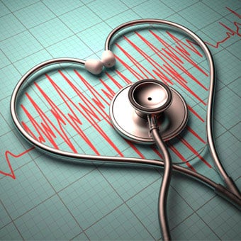 A stethoscope in the shape of a heart on a heartbeat pulse graph.