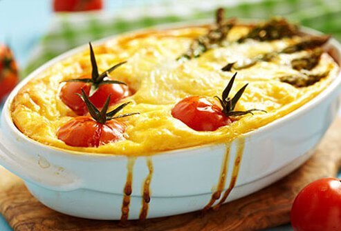 Photo of a quiche with tomato and asparagus.