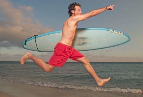 Man running with surfboard