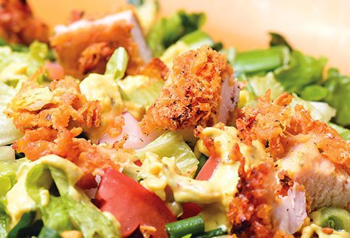 A green salad with chicken may sound like a healthy meal, but descriptions like crispy and crunchy are red flags.