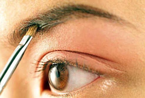 Photo of woman applying makeup.