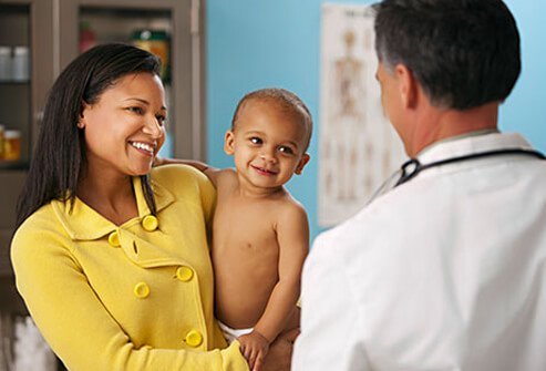 A woman and her baby with a doctor.