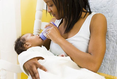 A mother feeds her baby.