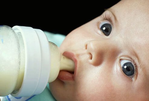 An infant drinking from a bottle.