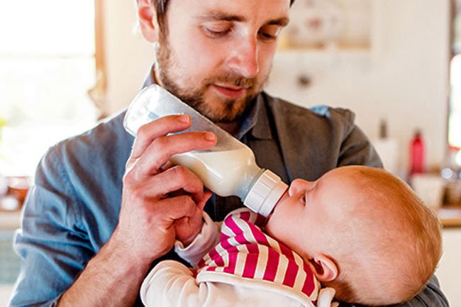 An infant with baby bottle.