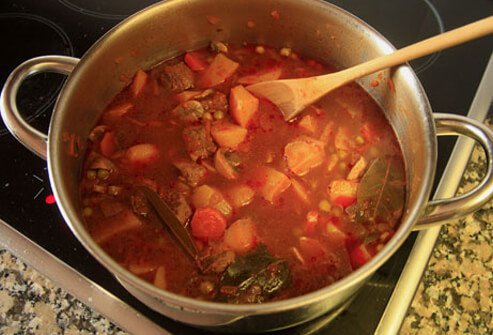 A pot of stew cooking on the stove.