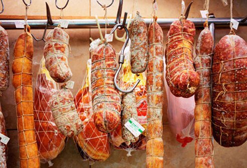 Salami and sausages hanging in the deli.