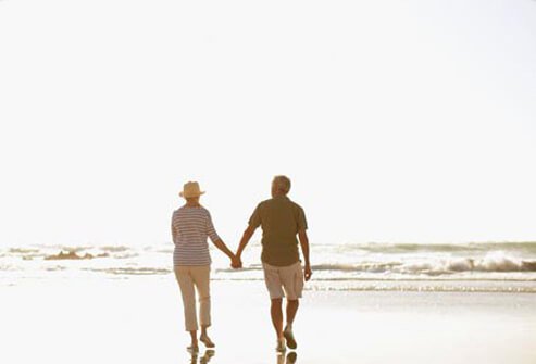 Photo of a couple walking on the beach, live a healthy life with COPD.