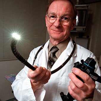 A doctor holds a colonoscope.