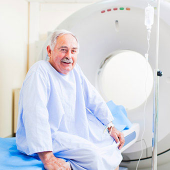 A senior man prepares for a virtual colonoscopy done via CT scan.