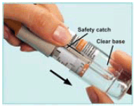 Press the safety catch while pulling off the clear base - Illustration