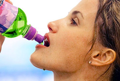  Picture of a woman is drinking electrolytes drink 