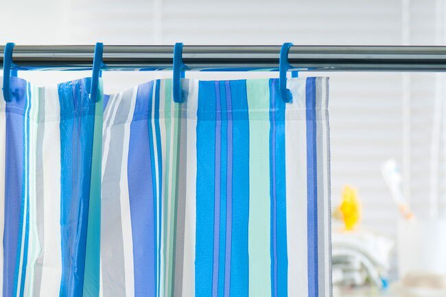 Clean your shower curtain regularly to remove soap scum and bacteria.