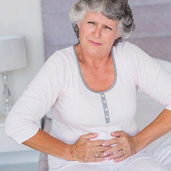 A woman experiencing abdominal pain.