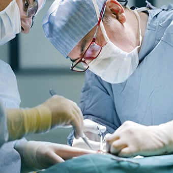 Doctors performing surgical treatment for diverticulitis.