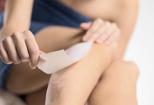 Photo of woman waxing legs.