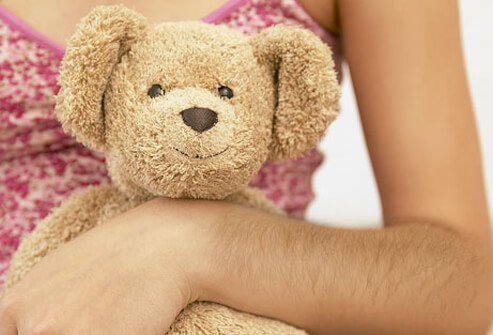 Photo of girl holding teddy bear.