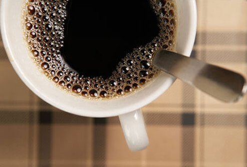 Photo of cup of coffee with spoon.