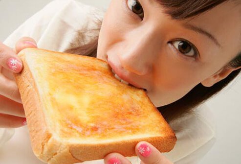 Photo of girl eating toast.