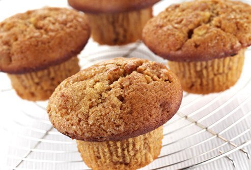 A photo of bran muffins on cooling rack.