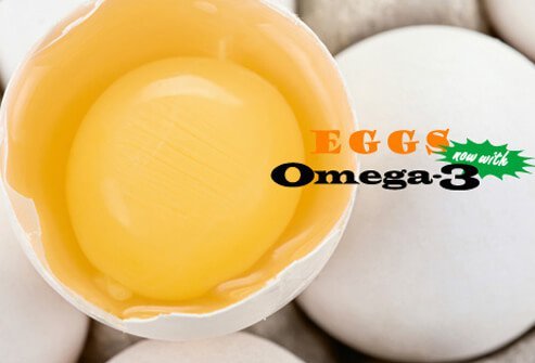 A photo of a raw egg in a carton.