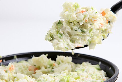 A photo of a spoonful of coleslaw.