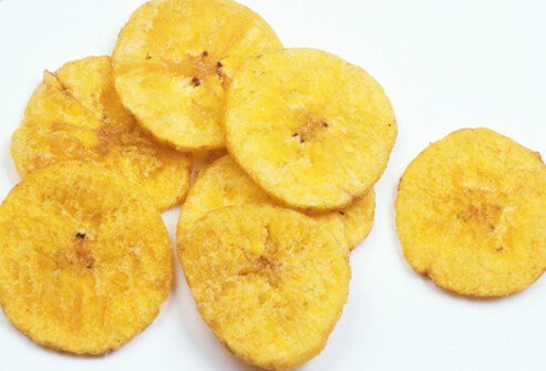 A photo of banana chips on a white table.