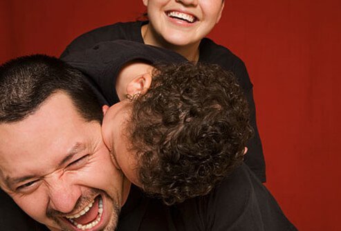 Photo of man laughing with son.