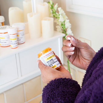 A woman takes antifungal nail medication.