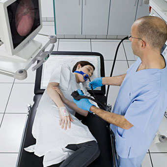 The doctor performs an endoscopic retrograde cholangiopancreatography (ERCP) on a woman for gallstones.