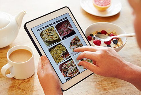A man plans out meals on an iPad.