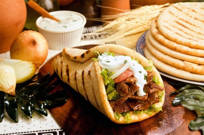Make a barbecue chicken wrap with rotisserie chicken, raw spinach, and diced onion.