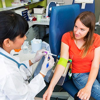 A woman has her blood drawn.
