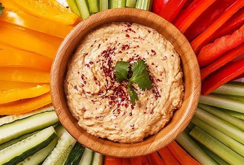 You'll save calories and add fiber and protein if you scoop up healthy spreads like hummus with celery, carrots, or sliced peppers instead of crackers or pita.